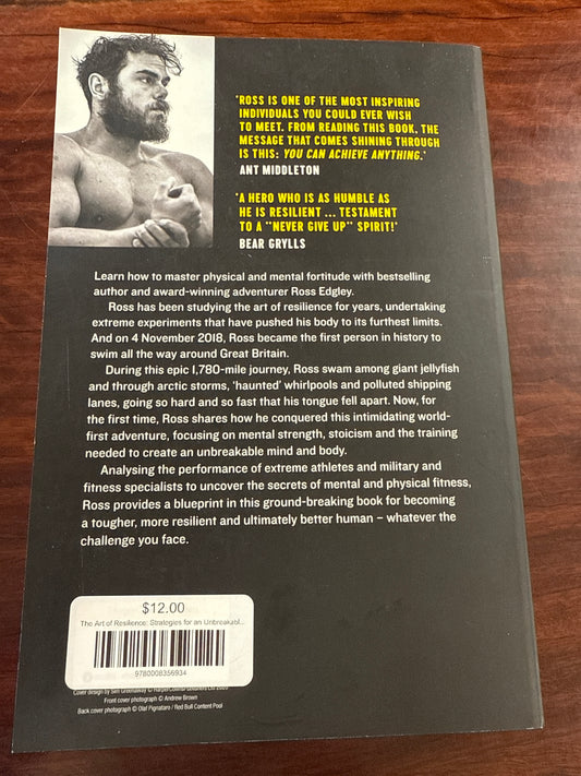 Back cover of 'The Art of Resilience' by Ross Edgley on a wooden surface