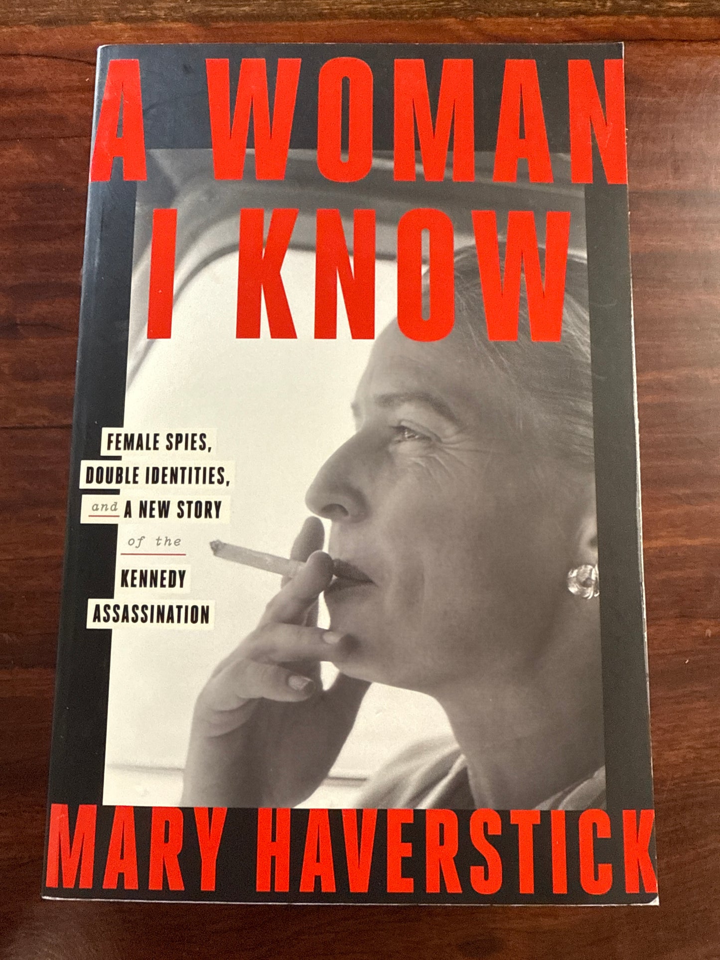 Book cover of 'A Woman I Know' by Mary Haverstick on a wooden surface