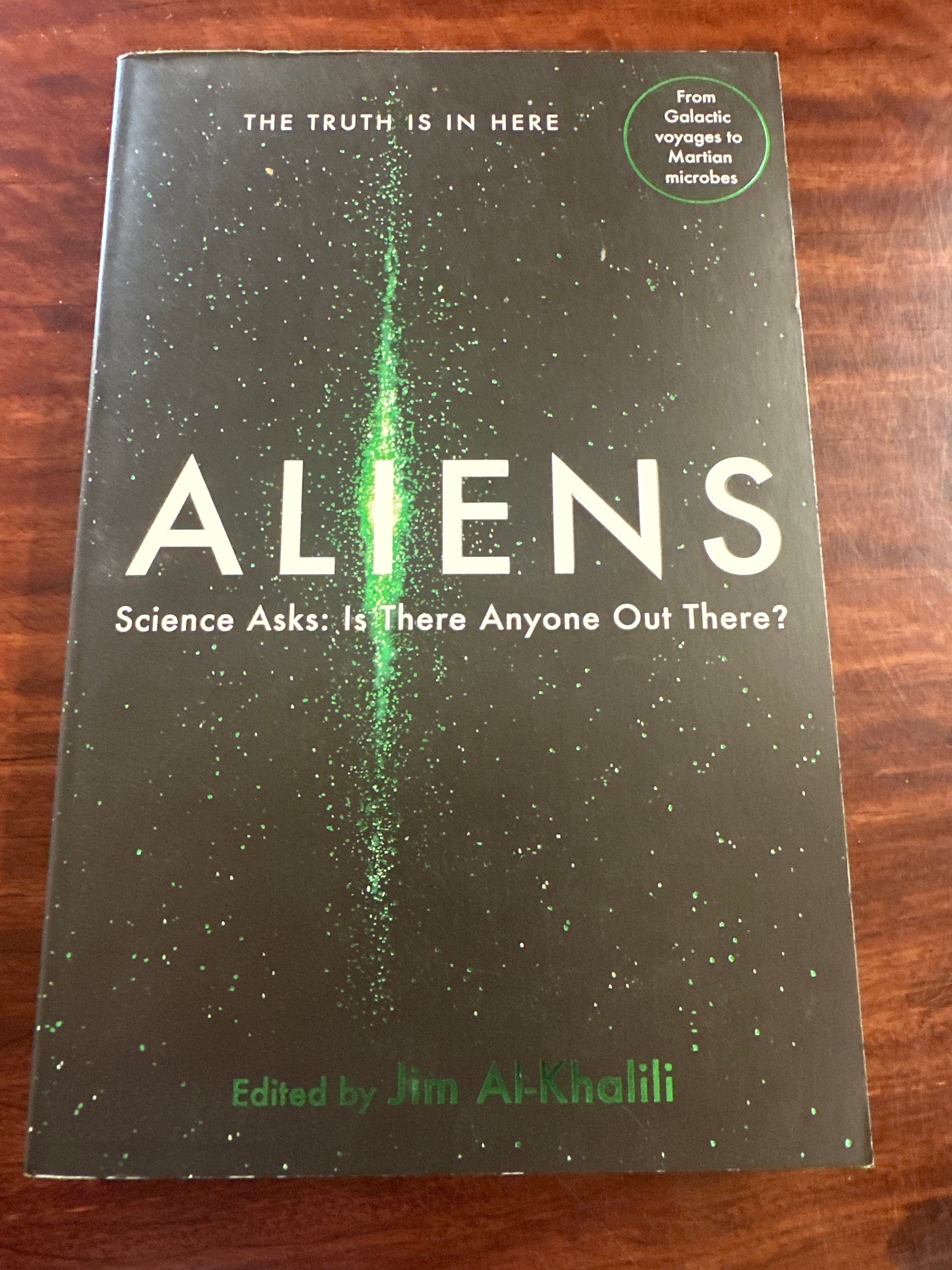 Aliens: Science Asks book cover on wooden surface
