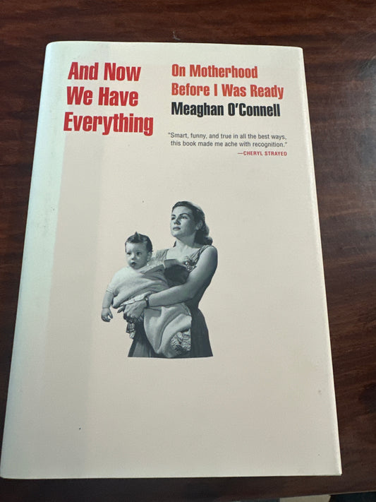 Book titled 'And Now We Have Everything' by Meaghan O'Connor on a wooden surface