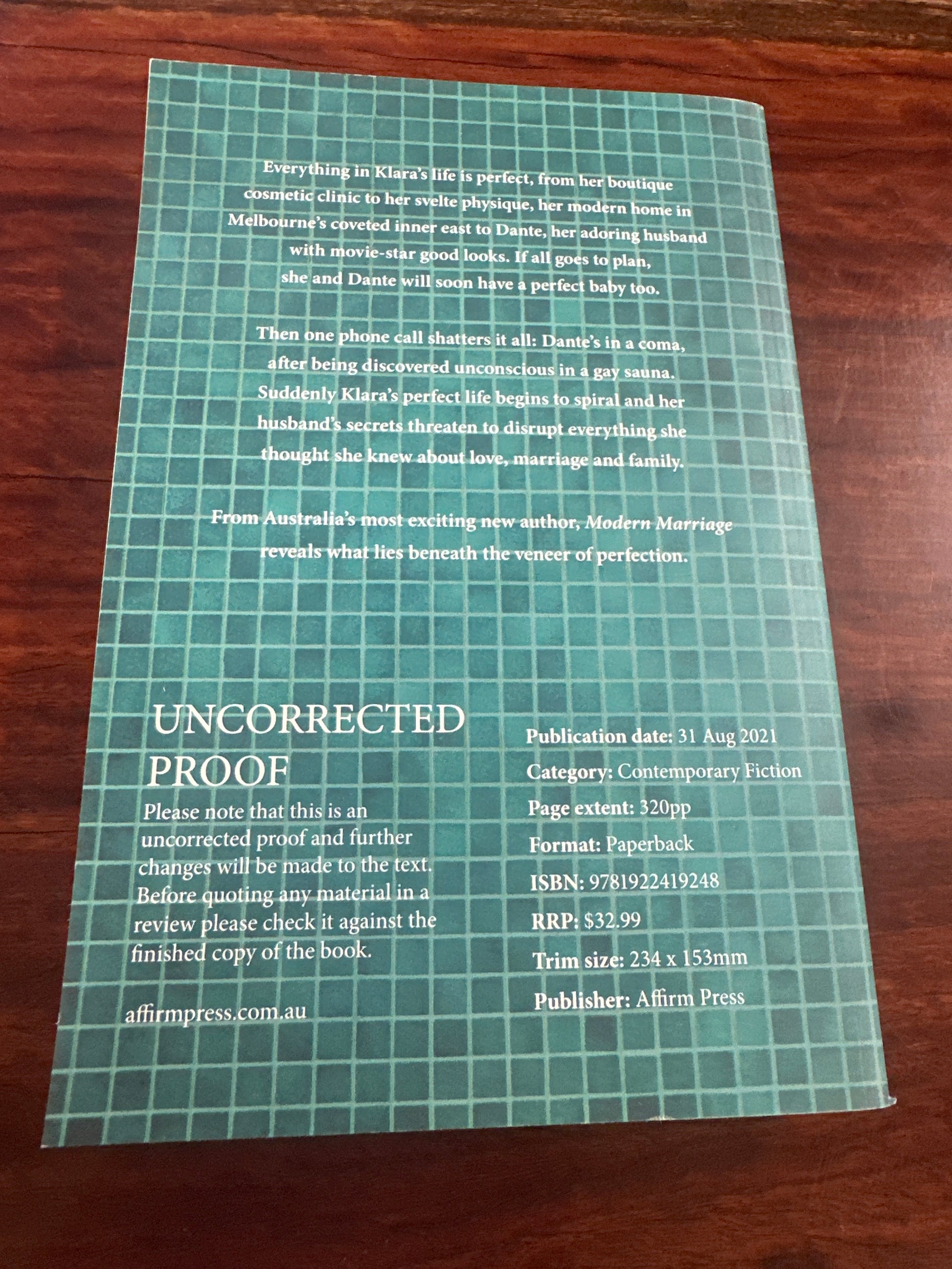 Back Book cover of 'Modern Marriage' by Filip Vukasin with a white dress on a wooden surface.