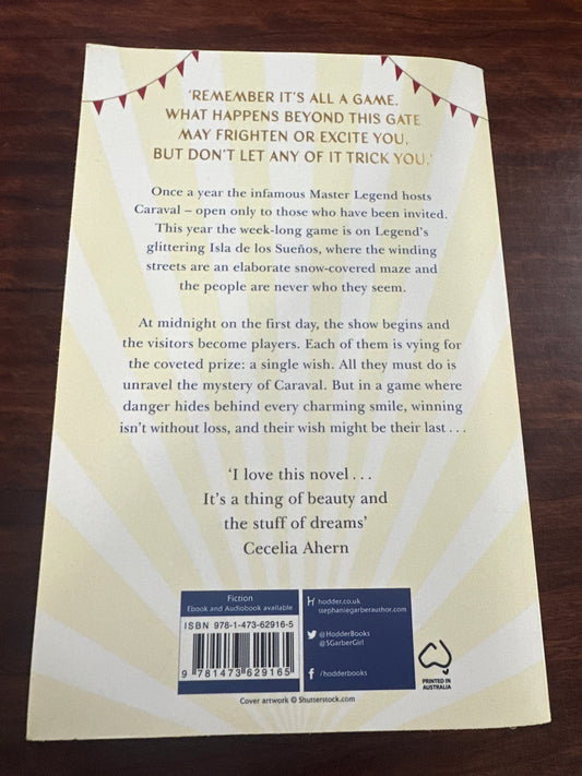 Back Book cover of 'Caraval' by Stephanie Garber on a wooden surface