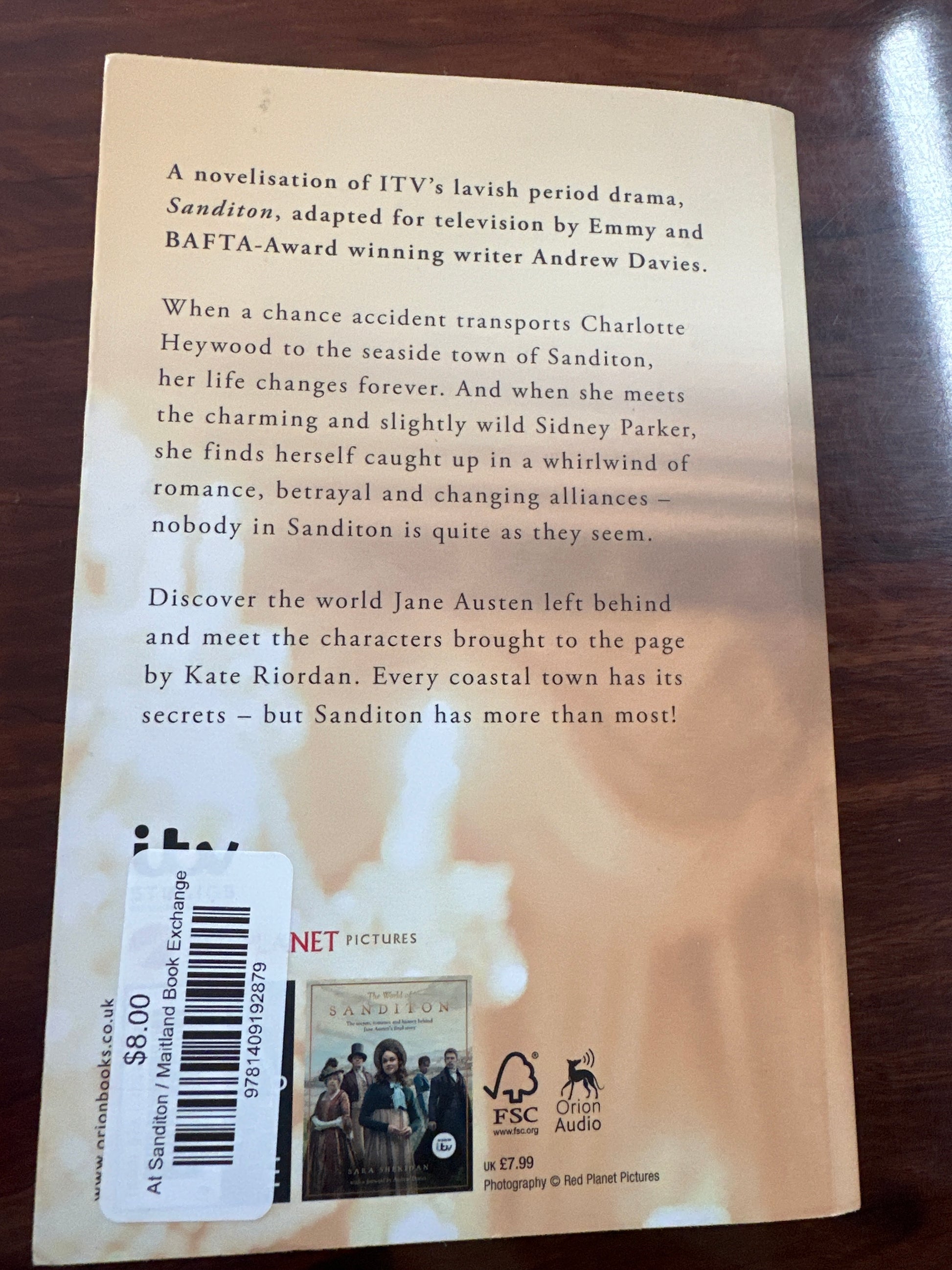 Back Book cover of 'Sanditon' by Kate Riordan on a wooden surface
