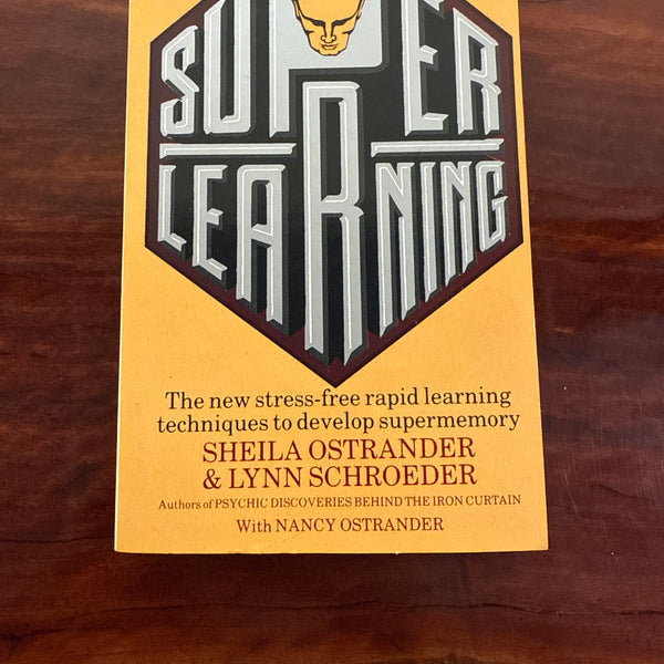 Book titled 'Building Learning Bridges' on a wooden surface