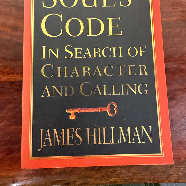 Book titled 'The Soul's Code' by James Hillman on a wooden surface