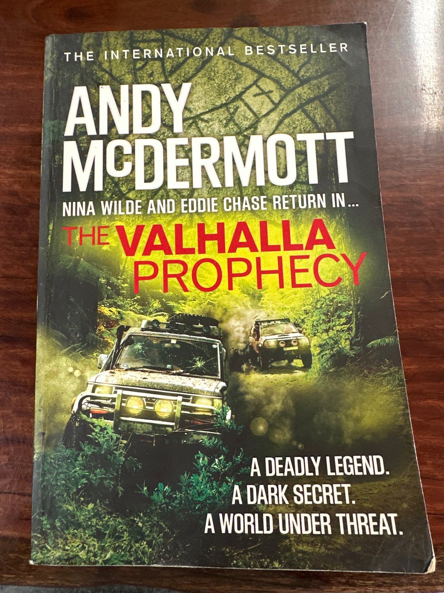 Book titled 'The Valhalla Prophecy' by Andy McDermott on a wooden surface