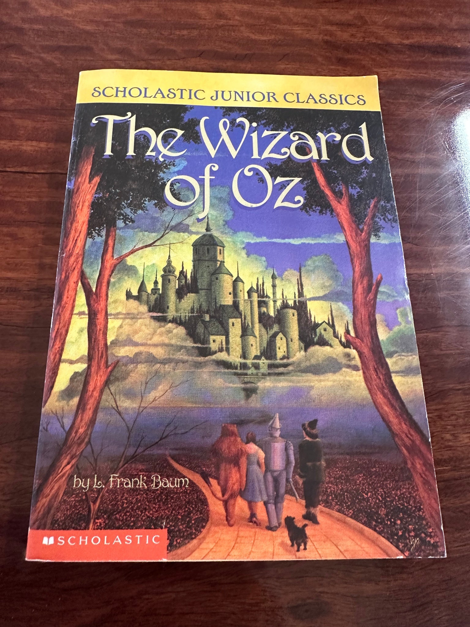 The Wizard of Oz cover showing Dorothy on yellow brick road walking towards Oz