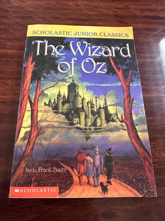 The Wizard of Oz cover showing Dorothy on yellow brick road walking towards Oz