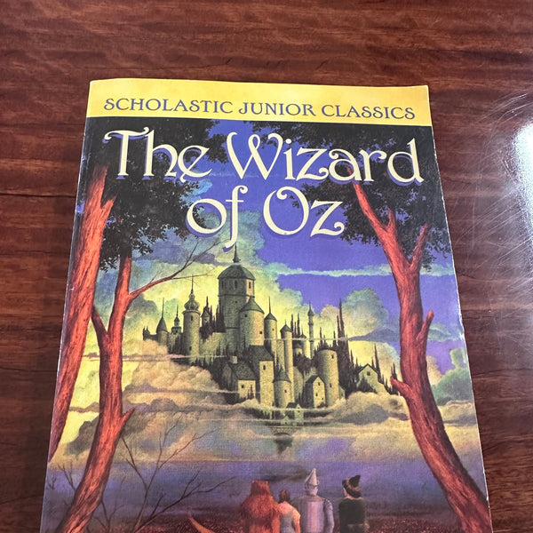 The Wizard of Oz cover showing Dorothy on yellow brick road walking towards Oz